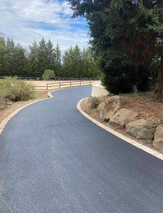 Asphalt driveway with red brick edging in Melbourne